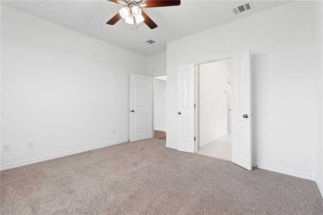 unfurnished bedroom featuring ceiling fan and light colored carpet