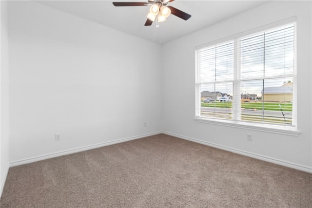 carpeted spare room with ceiling fan