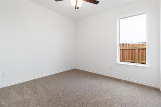 carpeted empty room featuring ceiling fan and a healthy amount of sunlight