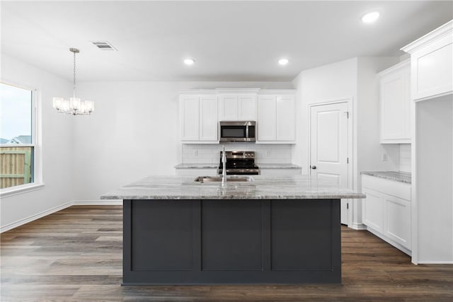 kitchen featuring white cabinets, light stone counters, sink, and appliances with stainless steel finishes