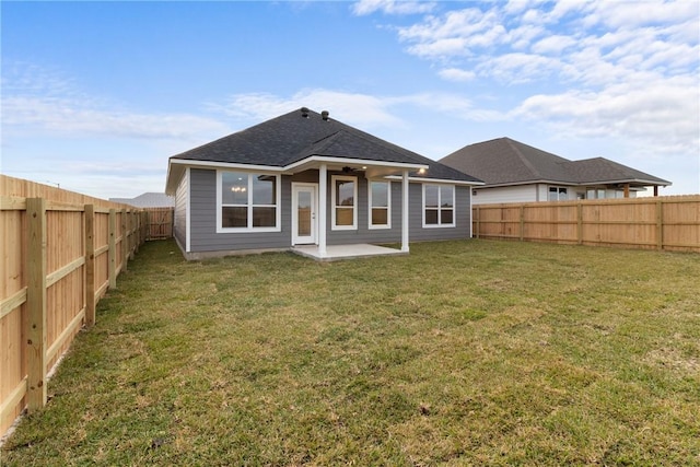 rear view of property with a lawn and a patio area