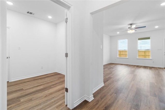 unfurnished room with ceiling fan and wood-type flooring