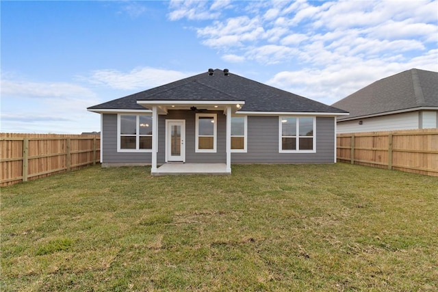 back of property with a lawn, ceiling fan, and a patio area