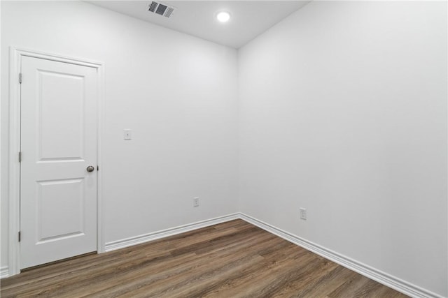 spare room featuring dark hardwood / wood-style floors