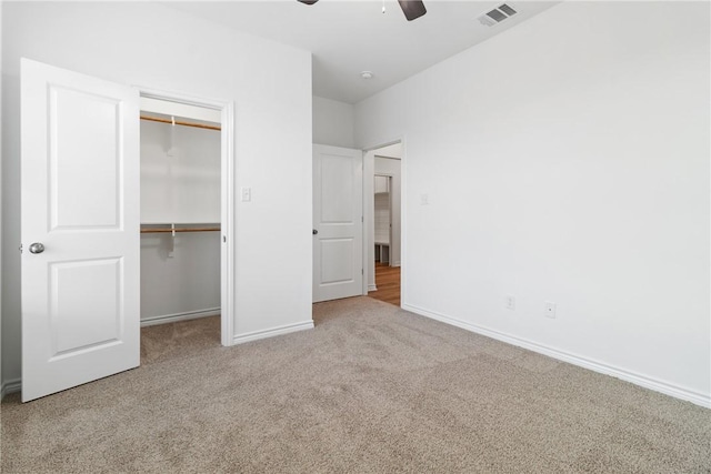 unfurnished bedroom featuring carpet floors, a closet, and ceiling fan