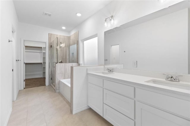 bathroom with tile patterned floors, vanity, and independent shower and bath