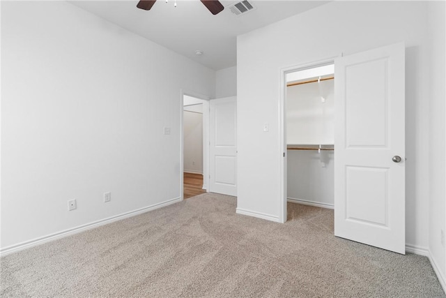 unfurnished bedroom with ceiling fan, a closet, and light colored carpet