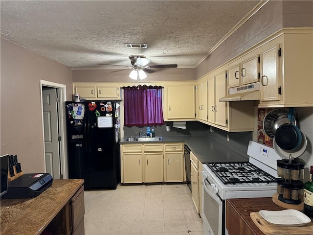 kitchen with black fridge with ice dispenser, white range with gas cooktop, and cream cabinets