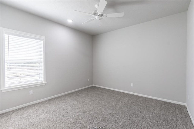 unfurnished room with ceiling fan and carpet flooring