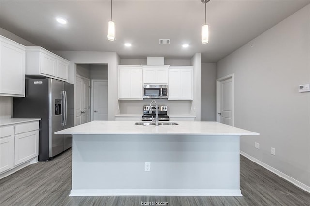 kitchen with white cabinets, hanging light fixtures, and appliances with stainless steel finishes