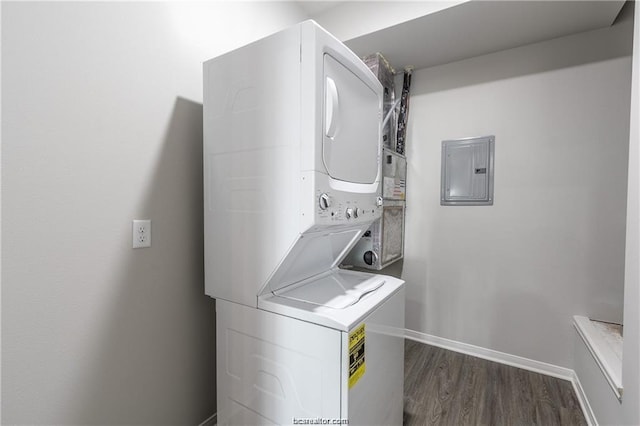 laundry room with electric panel, dark wood-type flooring, and stacked washer / dryer