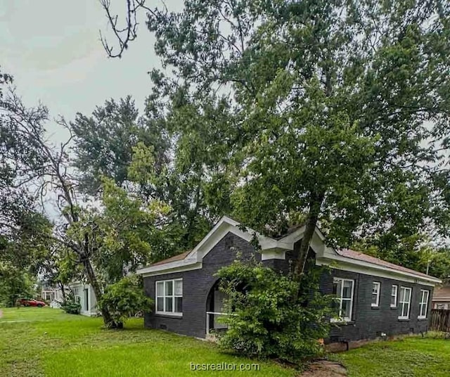 view of property exterior with a lawn