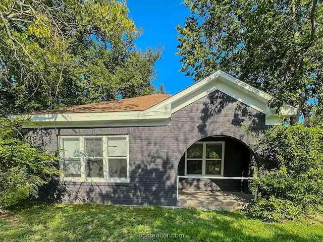 rear view of house with a yard