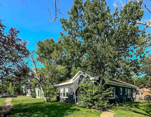 view of side of home featuring a lawn