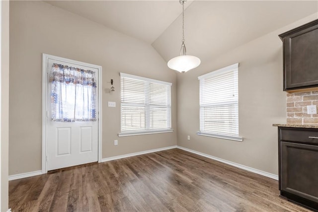109 Dove Ct, Navasota, TX 77868 - unfurnished dining area with lofted ceiling, wood finished floors, and baseboards