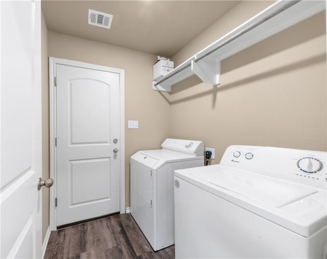109 Dove Ct, Navasota, TX 77868 - laundry room featuring washer and clothes dryer and dark wood finished floors