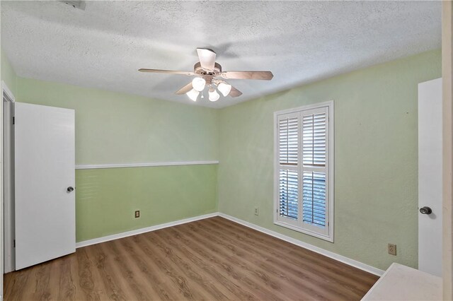 spare room with wood-type flooring, a textured ceiling, and ceiling fan