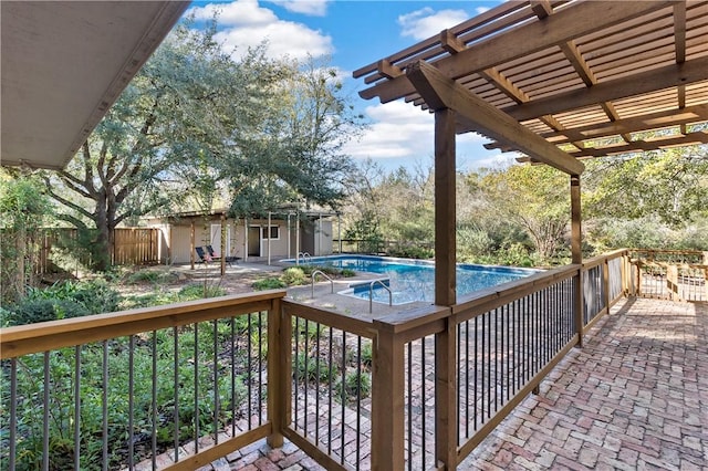 wooden terrace featuring a pergola, a fenced in pool, and a patio