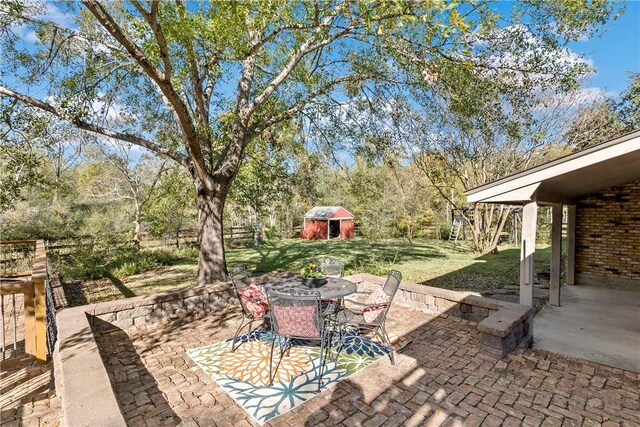 view of patio featuring a storage unit