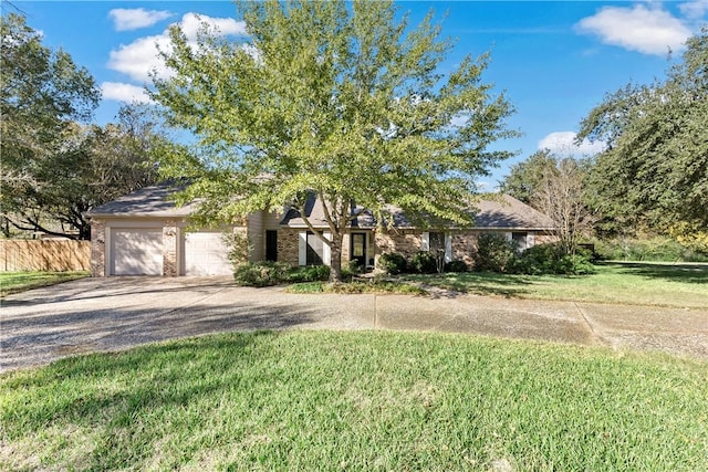 view of front of house with a garage and a front yard