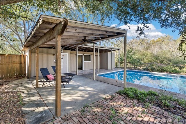 view of pool featuring ceiling fan and a patio