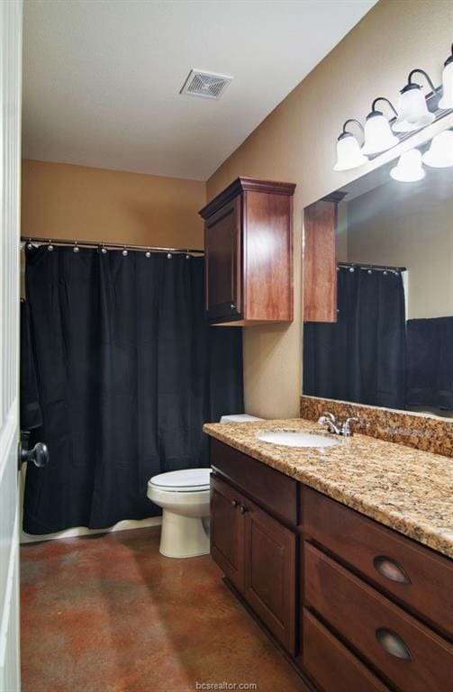 bathroom featuring concrete flooring, vanity, and toilet