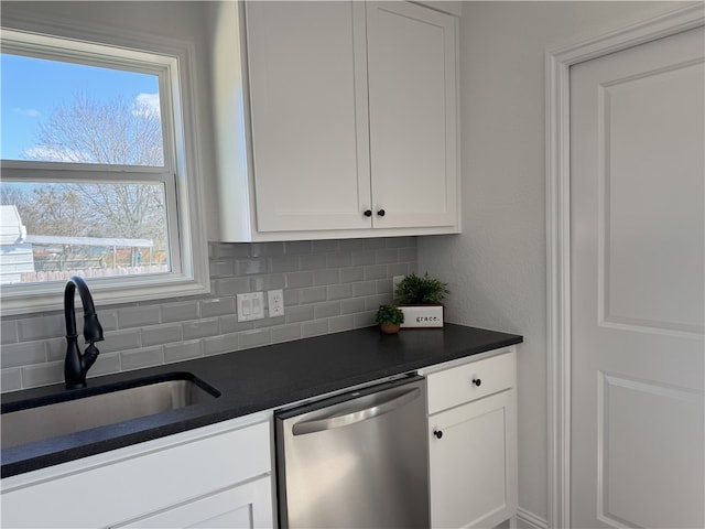 kitchen featuring dishwasher, sink, decorative backsplash, and white cabinets