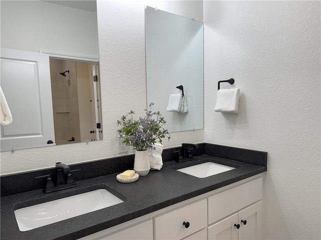 bathroom with vanity and a shower