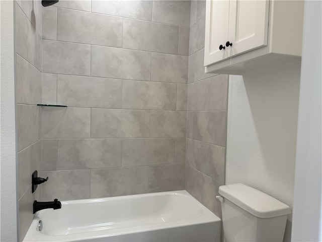 bathroom with tiled shower / bath and toilet