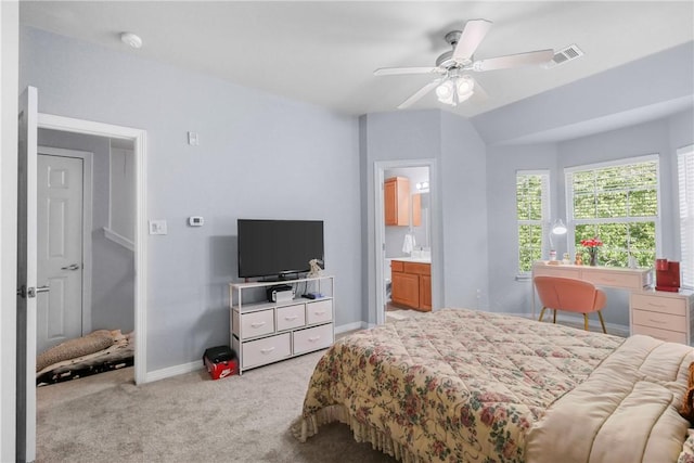 bedroom with visible vents, baseboards, ensuite bathroom, a ceiling fan, and light colored carpet