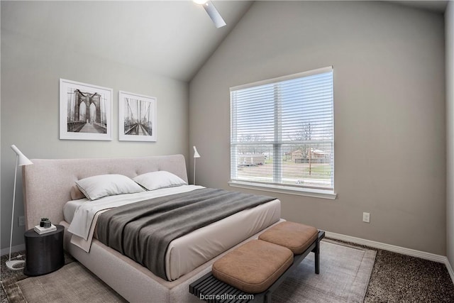 bedroom with carpet flooring, ceiling fan, and high vaulted ceiling