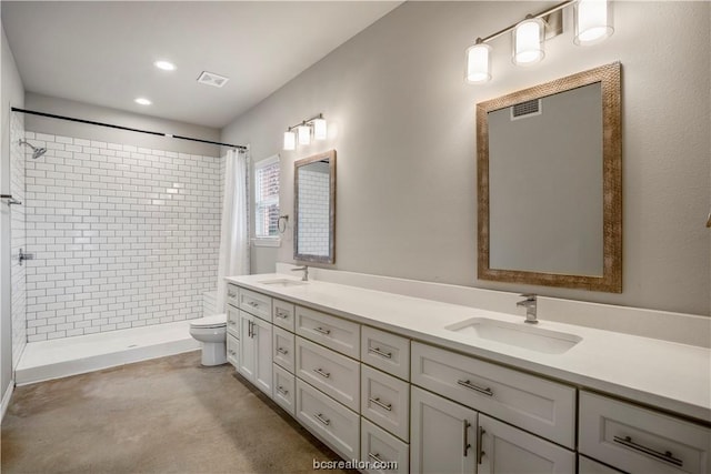 bathroom featuring concrete flooring, a shower with curtain, vanity, and toilet