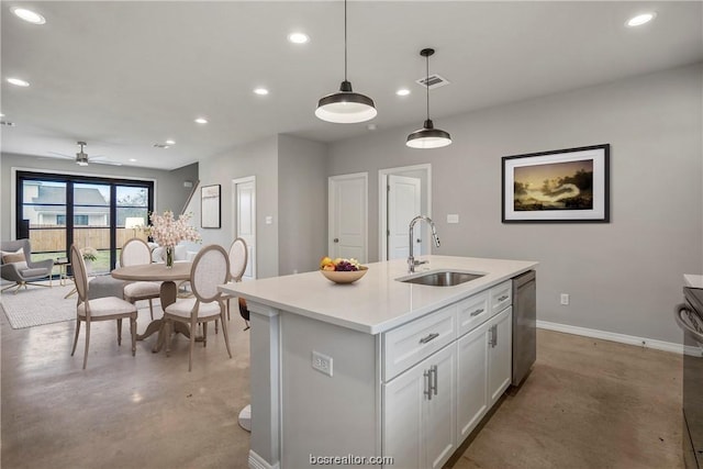 kitchen featuring ceiling fan, sink, stainless steel dishwasher, an island with sink, and pendant lighting