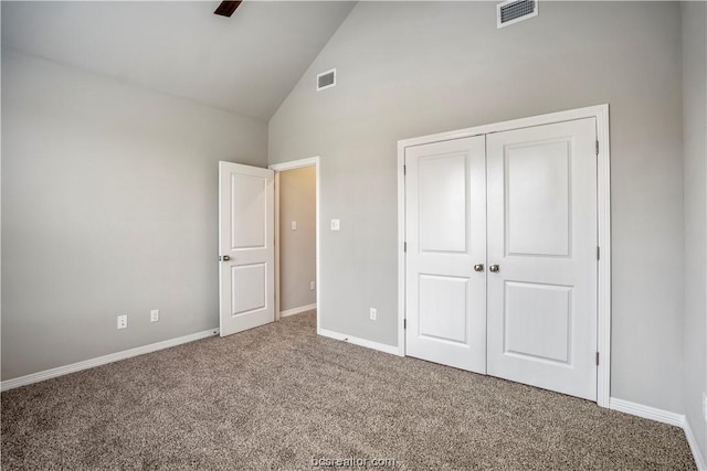 unfurnished bedroom with carpet, high vaulted ceiling, a closet, and ceiling fan