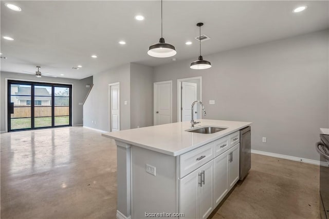 kitchen featuring stainless steel dishwasher, ceiling fan, sink, pendant lighting, and an island with sink