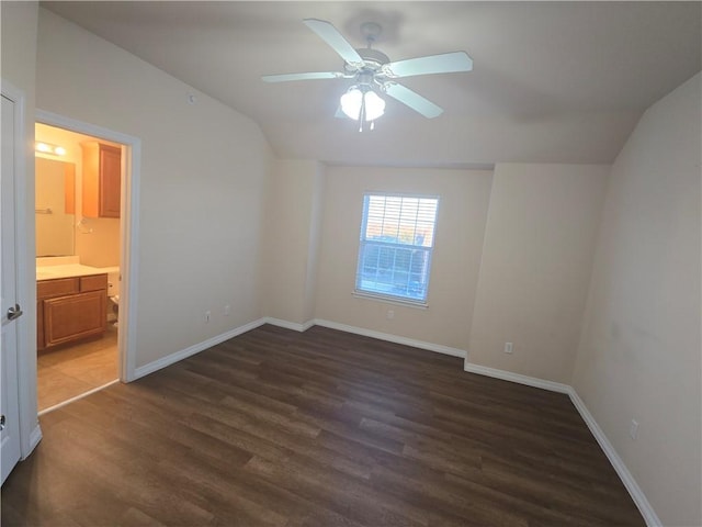 spare room featuring lofted ceiling, ceiling fan, and dark hardwood / wood-style floors