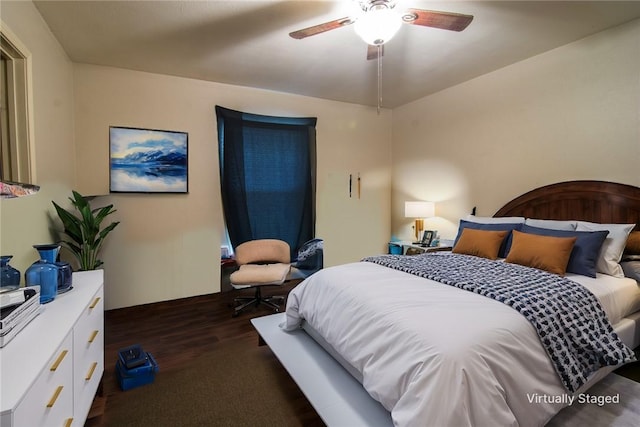 bedroom with dark hardwood / wood-style floors and ceiling fan