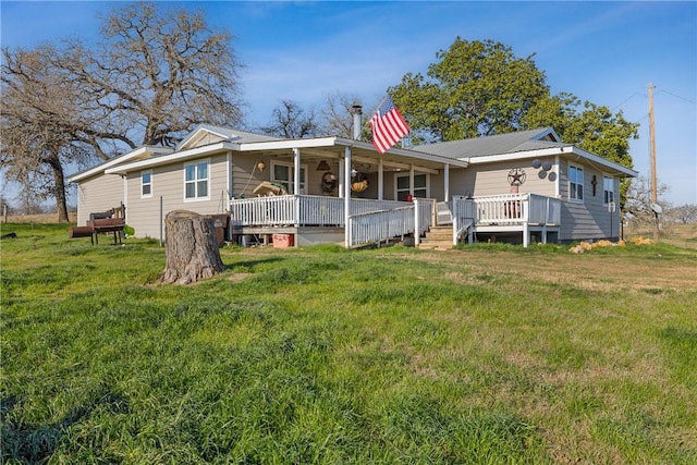 back of house with a wooden deck, a porch, and a yard