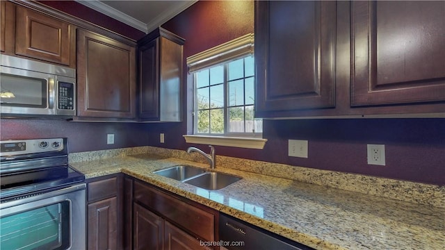 2487 Horse Shoe Dr, College Station, TX 77845 - kitchen with stainless steel appliances, a sink, crown molding, light stone counters, and dark brown cabinetry