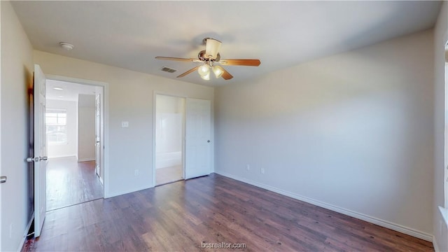 2487 Horse Shoe Dr, College Station, TX 77845 - unfurnished bedroom with dark wood-style flooring, baseboards, and ceiling fan
