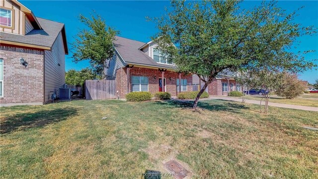 2487 Horse Shoe Dr, College Station, TX 77845 - obstructed view of property featuring brick siding and central AC