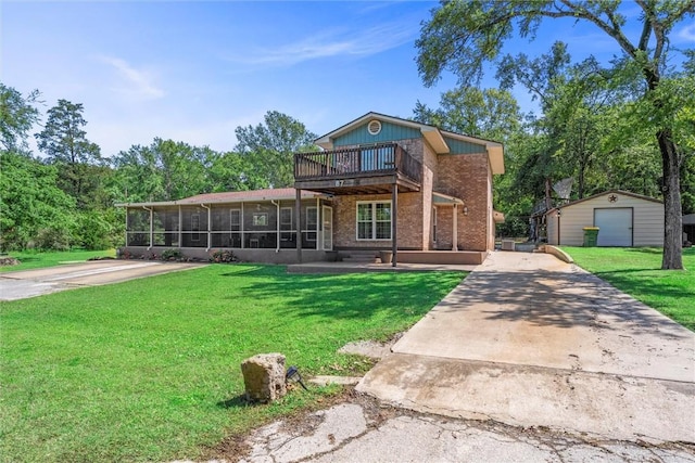 87 Tonkawa Dr, Normangee, TX 77871 - back of property with a sunroom, an outdoor structure, a lawn, brick siding, and driveway