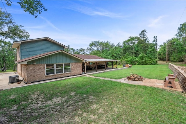 87 Tonkawa Dr, Normangee, TX 77871 - back of property featuring a patio area, brick siding, a lawn, and cooling unit
