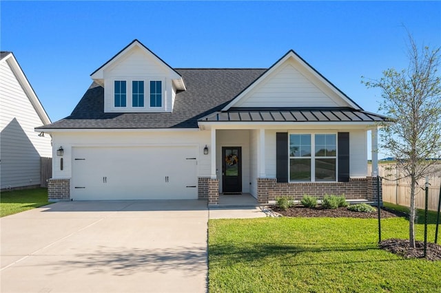 view of front of home with a front lawn, covered porch, and a garage