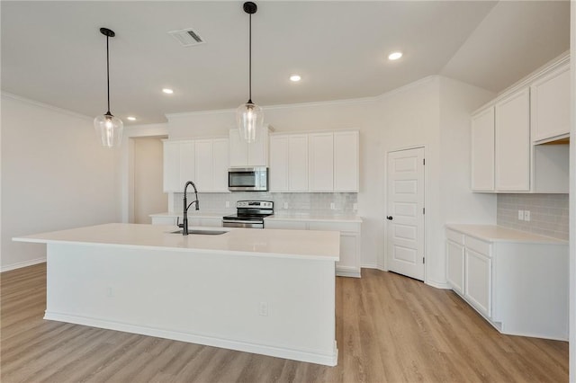 kitchen with sink, white cabinets, and appliances with stainless steel finishes