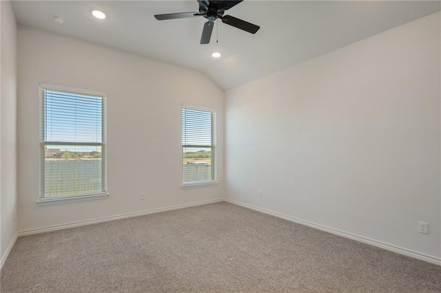 carpeted empty room with ceiling fan and vaulted ceiling