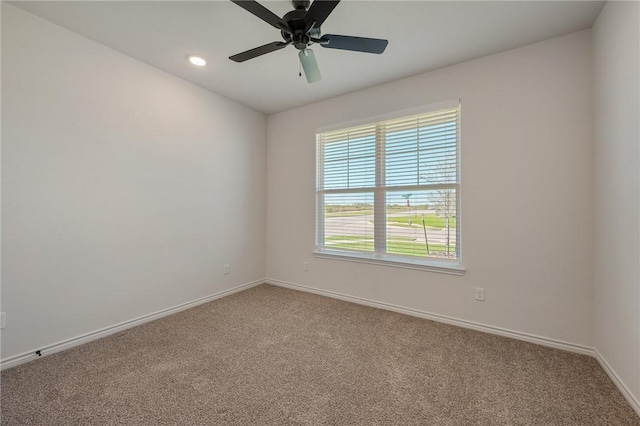 empty room with carpet flooring and ceiling fan