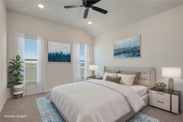 carpeted bedroom featuring multiple windows, ceiling fan, and lofted ceiling