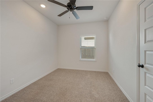 carpeted spare room with ceiling fan