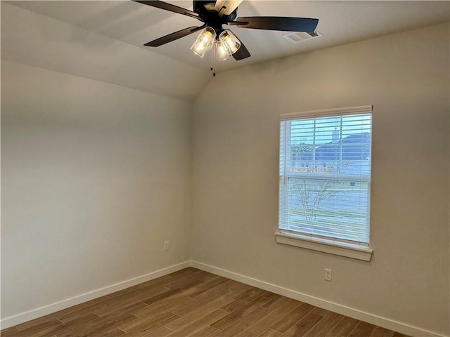 unfurnished room with ceiling fan, hardwood / wood-style floors, and lofted ceiling